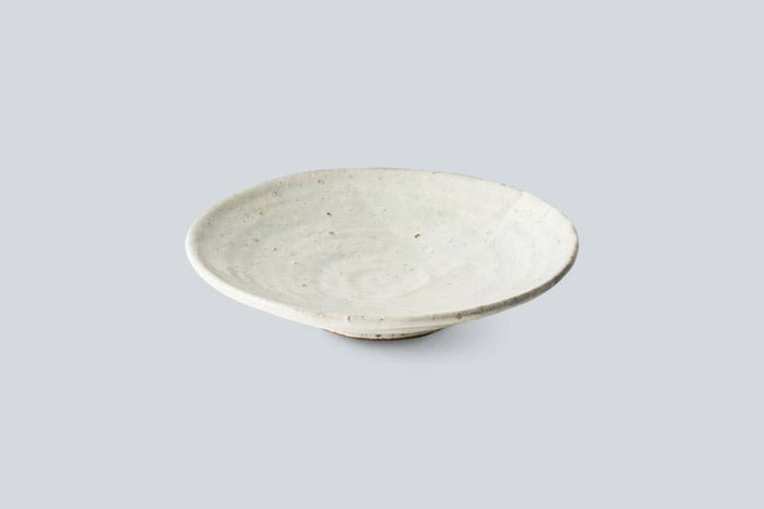 Handmade ceramic side plate, off-white speckled with a shallow bowl profile