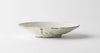 Handmade ceramic side plate in off-white, shallow rim with subtle speckling