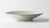 Handmade ceramic bowl, pale gray with speckled crackle glaze and low, wide shape.