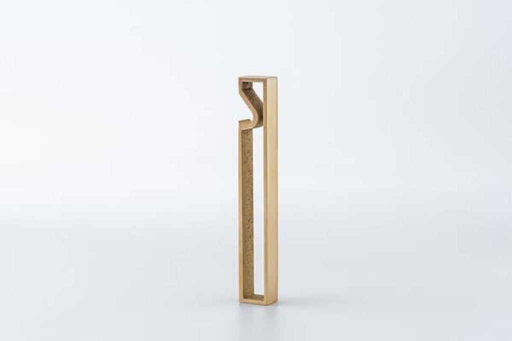 Brass bottle opener with upright rectangular frame and curved pry tip