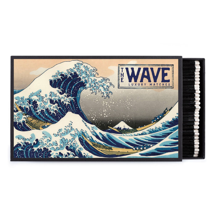 Giant safety match box with The Wave artwork and white matchsticks in tray