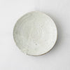 Round ceramic side plate, speckled off-white glaze with small pitted marks