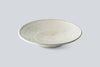 Handmade ceramic bowl in pale gray with speckled crackle glaze and wide rim.