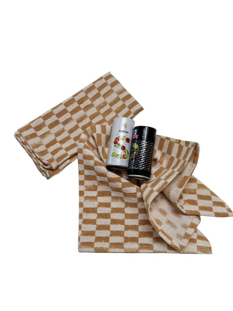 Rectangular checkered napkins, mustard and cream, layered folded set