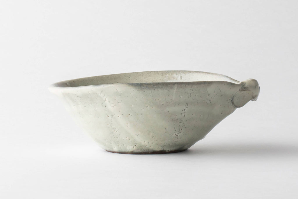 Handmade Japanese ceramic bowl with speckled light gray glaze and rounded spout