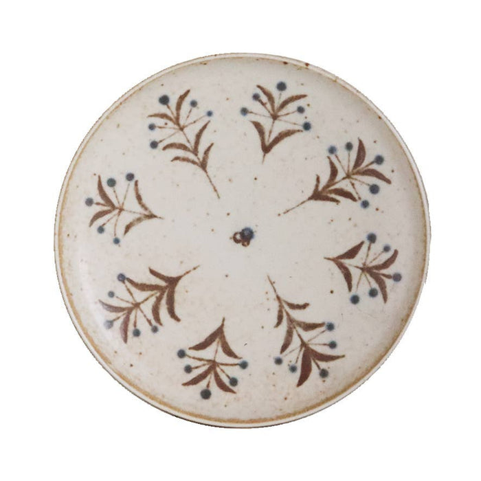 White porcelain dish with brown and blue floral pattern, round shallow plate