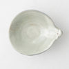 Handmade Japanese ceramic bowl interior, smooth light gray with rounded rim and spout