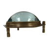 Antique brass dome desk magnifier with clear lens on four short feet