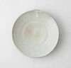 Round ceramic serving bowl with pale gray speckled crackle glaze, shallow interior.