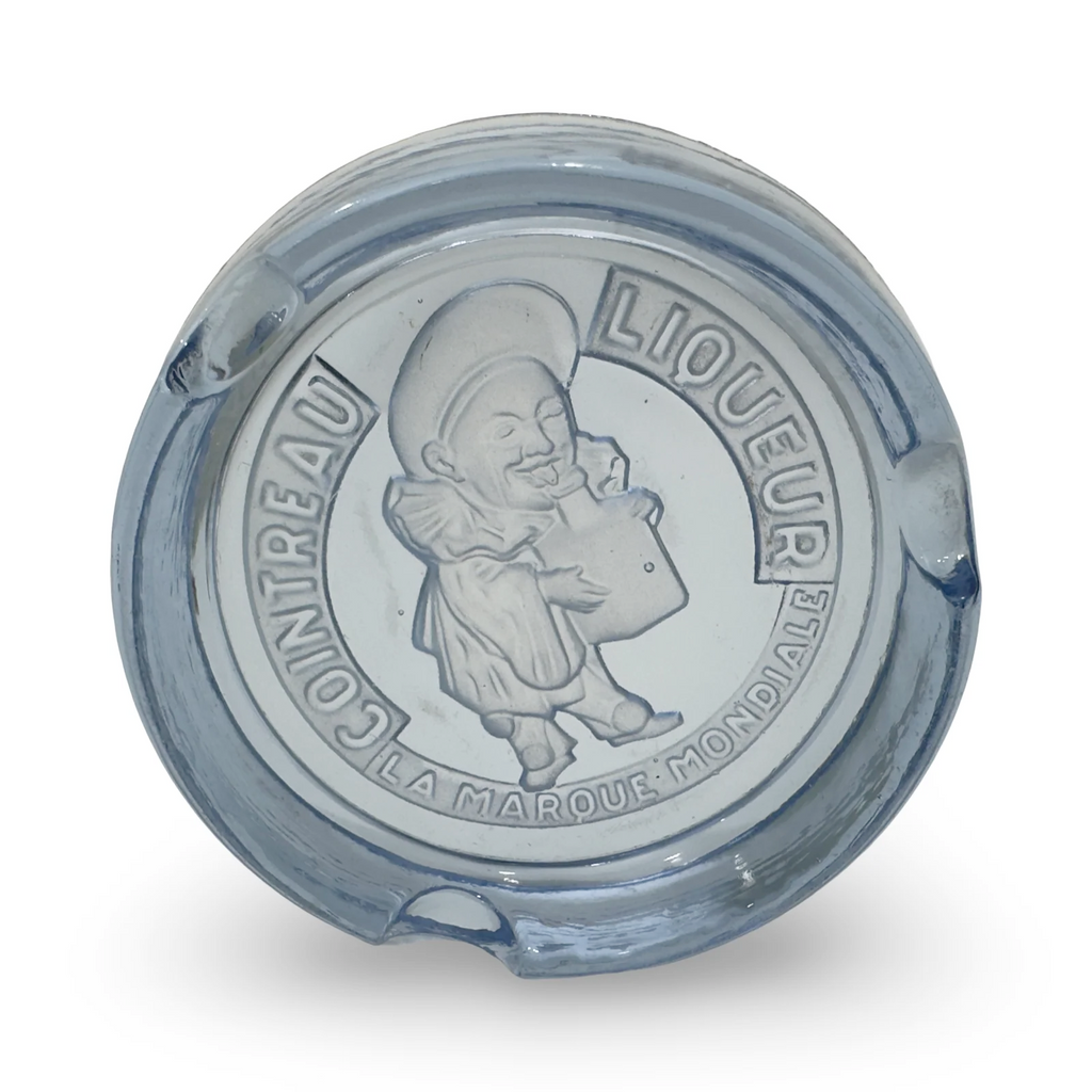Blue glass ashtray, angled view, embossed character and circular text on top