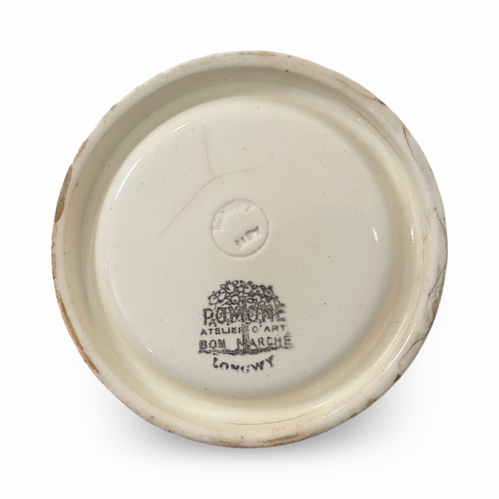 Bottom view of round ceramic ashtray with embossed maker stamp and text