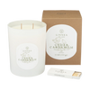 White glass jar candle with two wicks; Cedar Cardamom scent label on jar