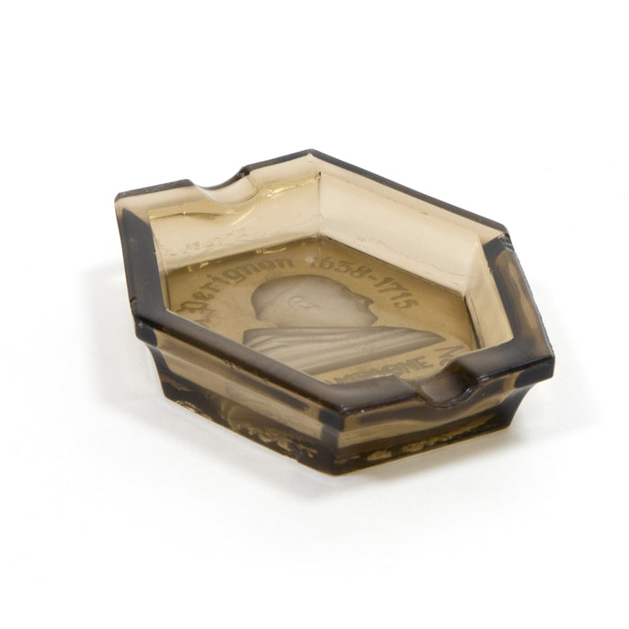 Dark amber glass ashtray with faceted hexagonal rim