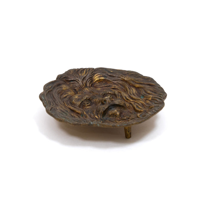 Bronze lion-face ashtray with raised mane and small pedestal base
