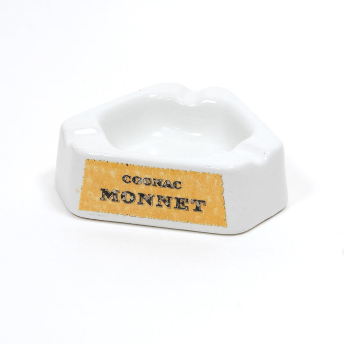 White ceramic ashtray with raised rim and Cognac Monnet logo on front