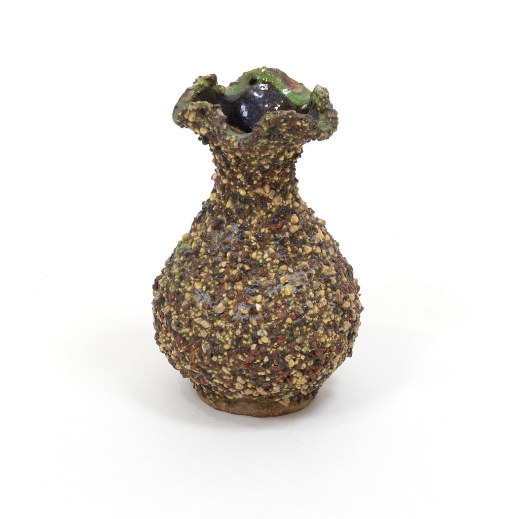 Speckled ceramic vase with flared rim and dark glossy opening