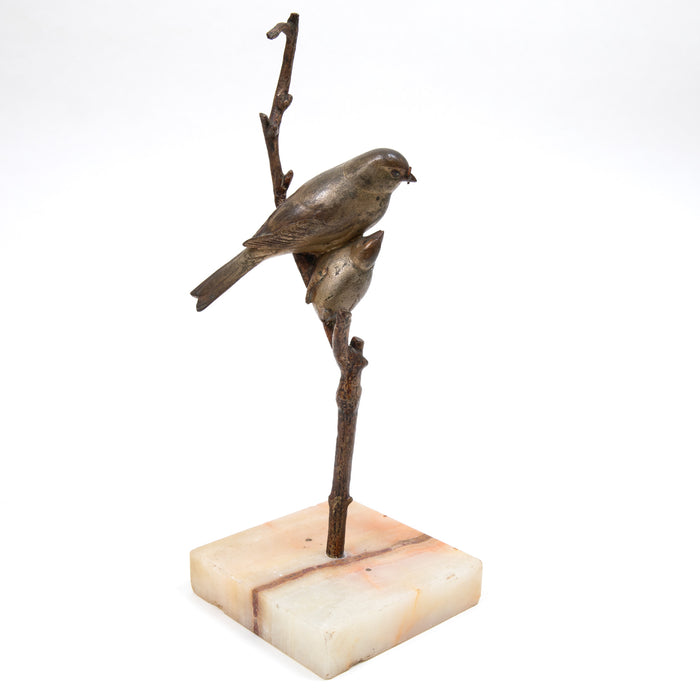Birds on branch sculpture with stone base