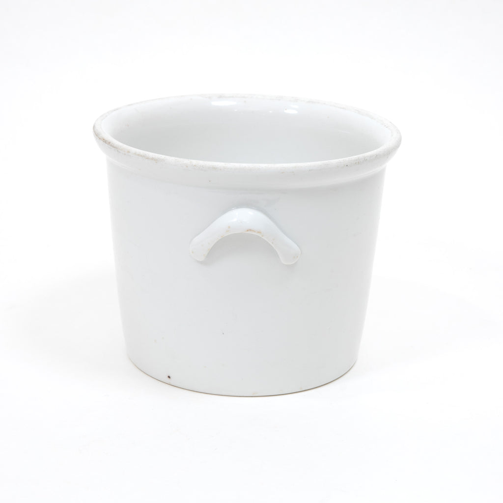 White stoneware ice bucket with front arched handle and wide round rim