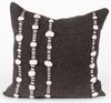 A square-shaped dark grey throw pillow with a pattern of tightly woven fabric and white raw wool accents.
