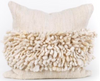 Decorative pillow with textured fringe on a white background