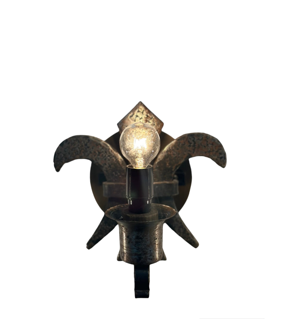 Antique-style metal fleur de lis wall sconce with candle bulb