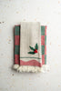 Holly embroidered tea towel set with cream fabric, green/red stripes, and fringed edges