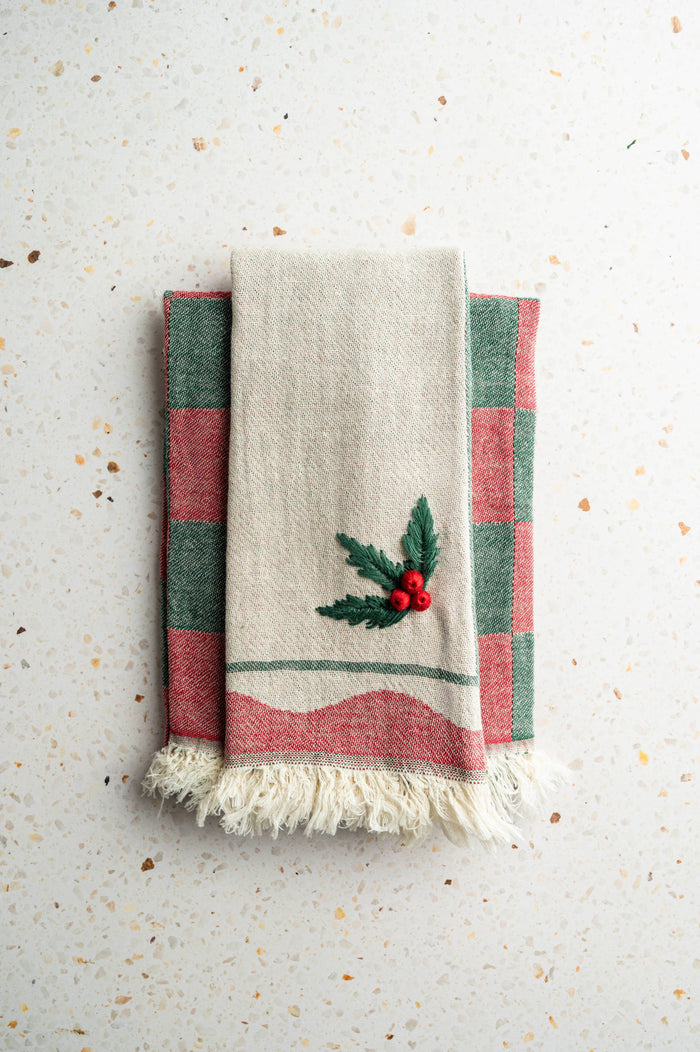 Holly embroidered tea towel set with cream fabric, green/red stripes, and fringed edges