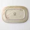 Speckled oval porcelain plate bottom with maker stamp