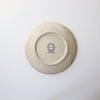 Speckled beige porcelain dish bottom with brand stamp and maker mark