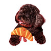 Croissant dog toy in brown and yellow stripes, shown on a curly dark dog