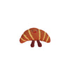 Hand-crocheted croissant dog toy with brown and yellow striped fabric and smile face