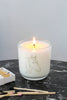 Lit horse soy wax candle in a clear glass tumbler with a line-art horse design.