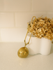 Gold stainless steel tea strainer with round perforated mesh ball and wire handle