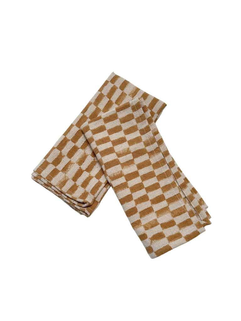 Rectangular checkered napkins, mustard and cream, folded pair
