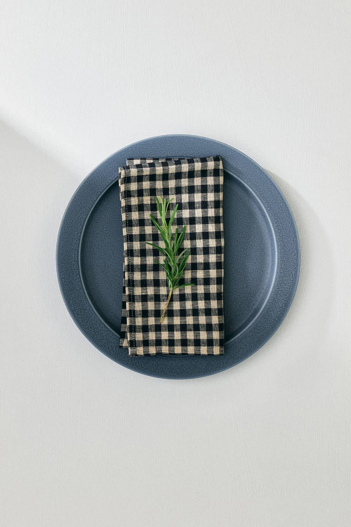Linen check napkin with green sprig, neatly folded