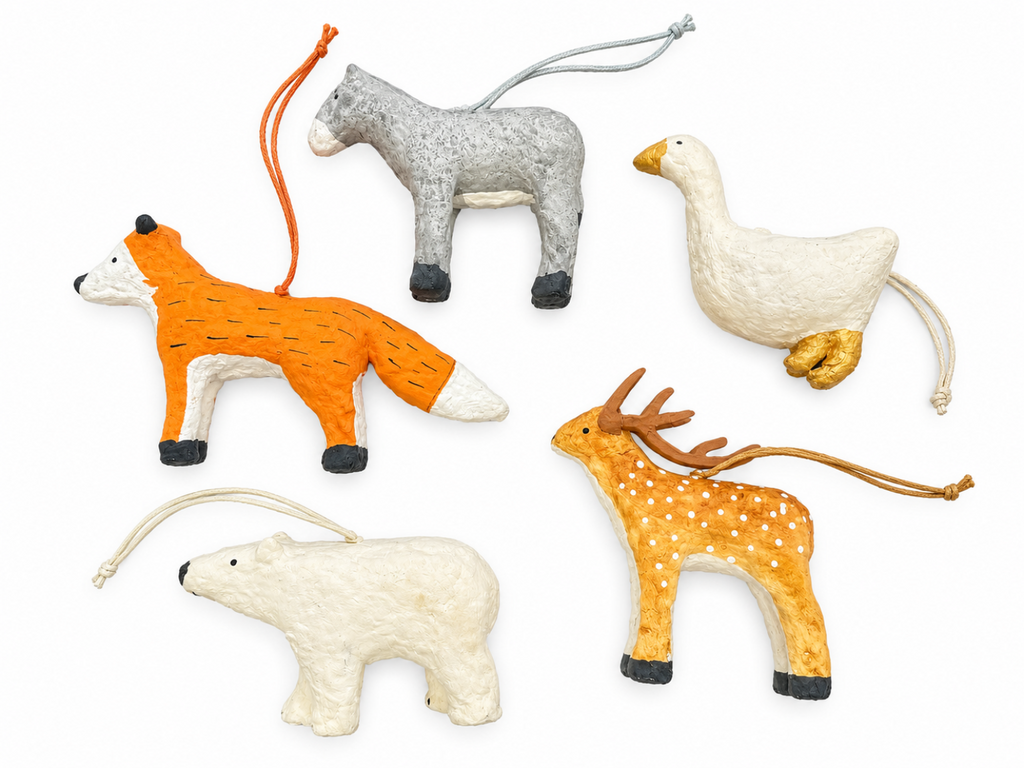 Assorted paper mache animal ornaments in orange, white, gray, and brown tones