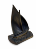 Bronze sailboat sculpture on a white background