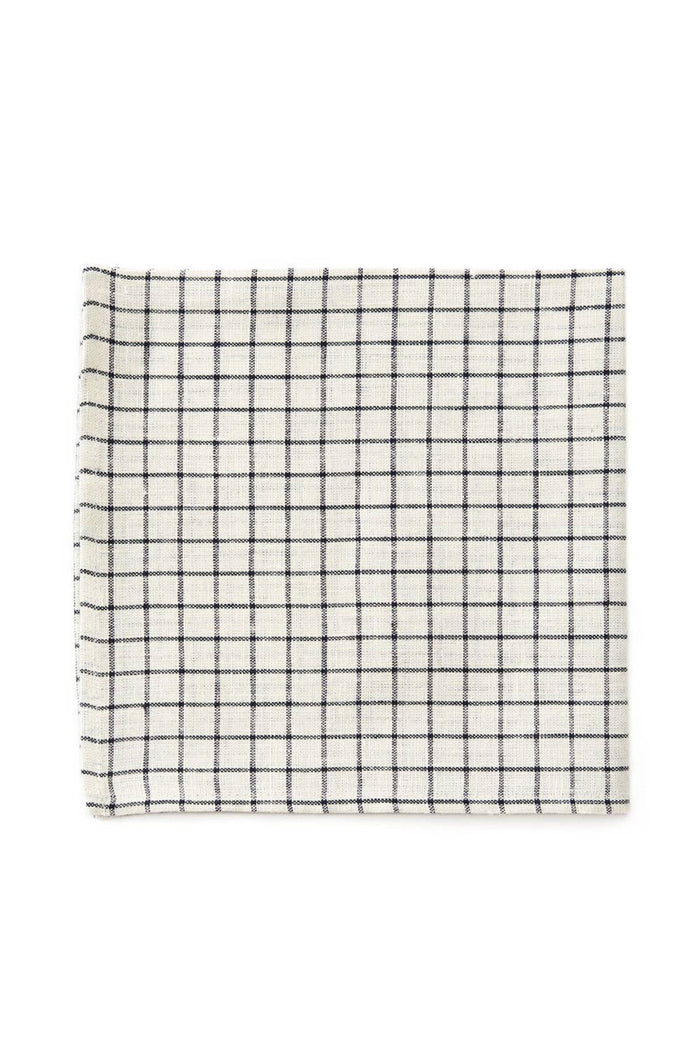 Jenn linen napkin featuring a blue check grid pattern