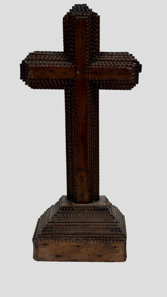 Dark brown wooden standing cross with detailed cutout trim and base plaque